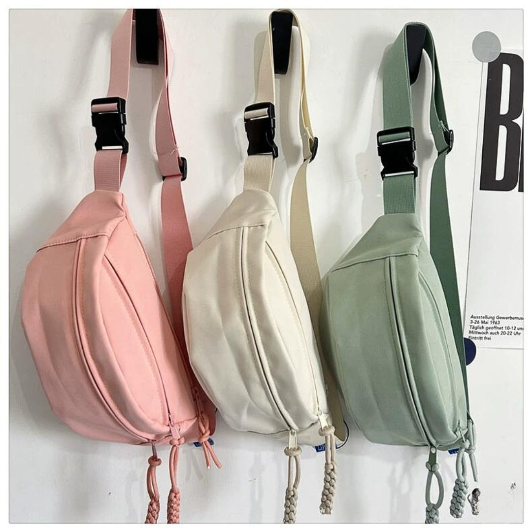 Solid-color cross-body bag for travel with pendant