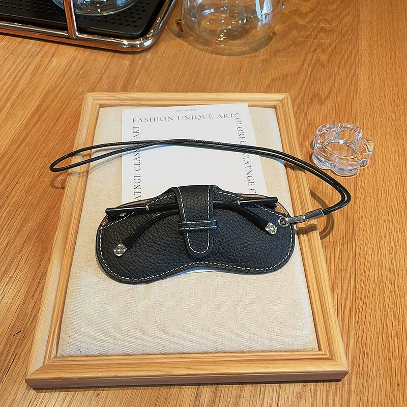 Portable lather glass protective storage with lanyard.